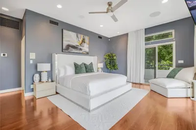 a bedroom with a white bed and a blue wall at Franklin Mediterranean Villa in Los Angeles