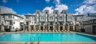 a large building with a swimming pool in front of it at 1311WCara in Anaheim