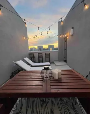 a room with two beds and a table with lights at 1311WCara in Anaheim