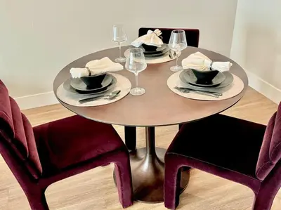 a dining room table with plates and wine glasses at Cozy Large 1 Bedroom Condo by UCLA in Los Angeles