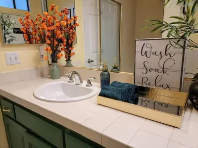 a bathroom counter with a sink and a mirror at Spacious studio with two queen beds near Beverlywood 5 minutes to Rodeo Drive in Los Angeles