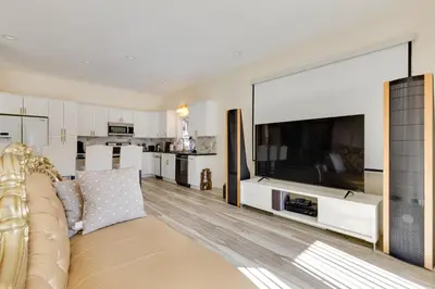 a living room with a large television and a couch at Game Room and Deck Modern Frazier Park Home! in Pine Mountain Club