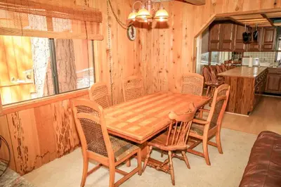 a dining room with a wooden table and chairs at A Big Olympic Getaway in Big Bear Lake