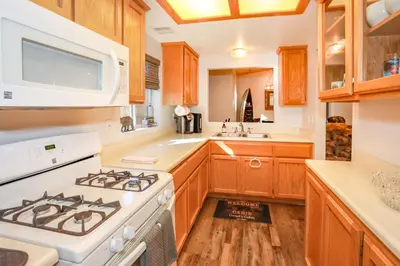 a kitchen with a stove and a sink at Comet's Cabin in Big Bear Lake