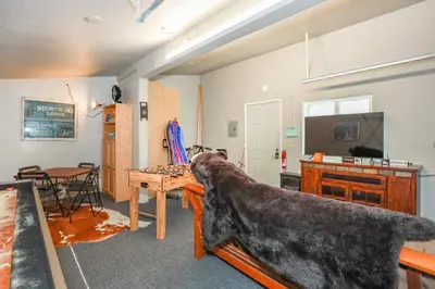 a large dog is sitting on a table in a room at Comet's Cabin in Big Bear Lake