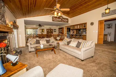 a living room with couches and a ceiling fan at Majestic Pines in Big Bear Lake