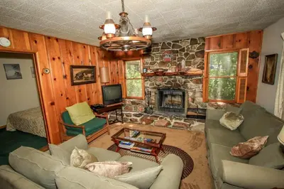 a living room with a couch and a fireplace at Mountain Air in Big Bear Lake