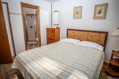 a bedroom with a bed with a striped comforter at Mountain Air in Big Bear Lake