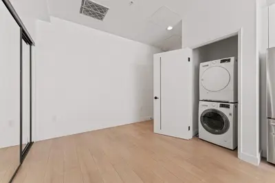 a laundry room with a washer and dryer at Stylish LA Getaway near Downtown - Prime Location on Wilshire Blvd! in Los Angeles