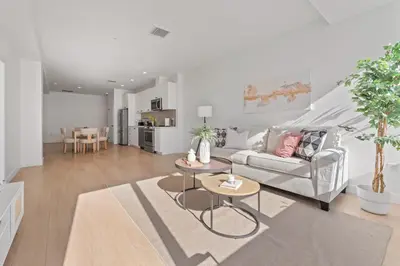 a living room with a couch and a table at Stylish LA Getaway near Downtown - Prime Location on Wilshire Blvd! in Los Angeles