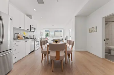 a kitchen and dining room with a table and chairs at Modern Retreat in Koreatown - Perfect for Your LA Stay! in Los Angeles