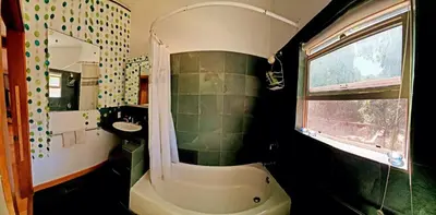 a bathroom with a sink and a bath tub and a window at Sparkling Gem Set Between Mountain and Ocean in Topanga