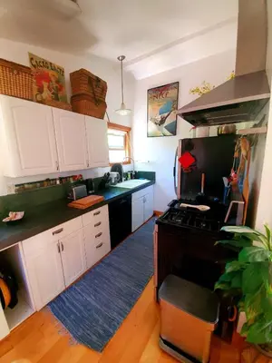 a kitchen with white cabinets and a black stove at Sparkling Gem Set Between Mountain and Ocean in Topanga