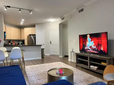 a living room with a flat screen tv on a wall at Spacious 1bdrm apartment 10 mins to Cedars-Sinai by car FREE Parking, King bed in Los Angeles