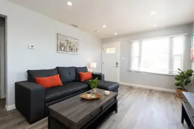 a living room with a black couch and a table at Chic Getaway Cozy Comfortable and Convenient with Two Bedrooms in Los Angeles