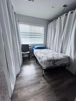 a bedroom with a bed and a window with curtains at Westminster Home in Westminster