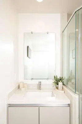 a white bathroom with a sink and a mirror at New Modern 3BR 3BA Apt in Central Los Angeles with Rooftop & Parking in Los Angeles