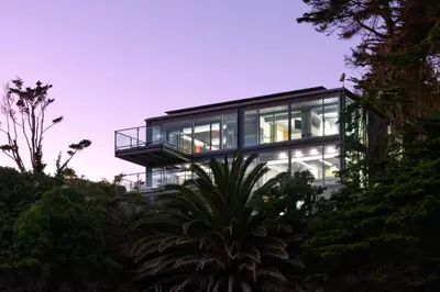 a glass house on the side of a hill at Beachfront Villa Broad Beach Direct Beach Access in Malibu