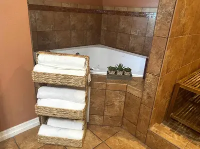 a bathroom with a bath tub with three folded towels at Hilltop Oasis Near Palos Verdes in San Pedro