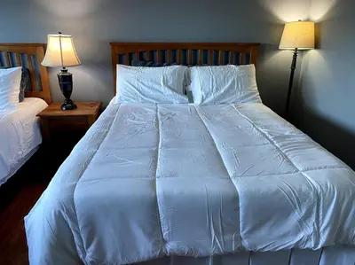 a large white bed with white sheets and pillows at Hilltop Oasis Near Palos Verdes in San Pedro