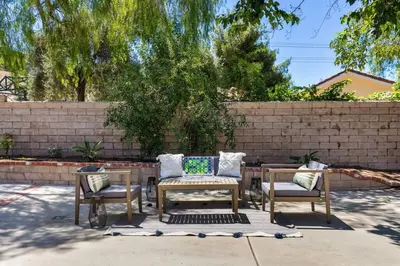three chairs and a table in front of a wall at GOODE HOMES Cozy 4 Bedroom Home with Jacuzzi in Santa Clarita