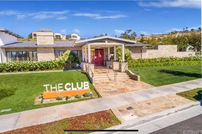 a house with a sign that reads the club at GOODE HOMES Luxury Modern Home with Pool and Spa in Santa Clarita
