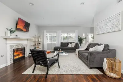 a living room with a couch and a chair and a fireplace at GOODE HOMES Luxury Modern Home with Jacuzzi in Santa Clarita