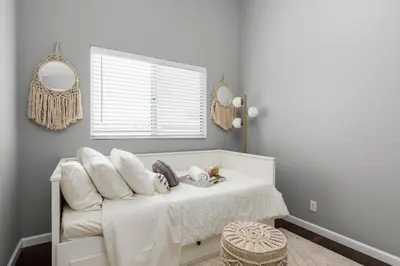 a bedroom with a bed with white sheets and pillows at GOODE HOMES Luxury Modern Home with Jacuzzi in Santa Clarita