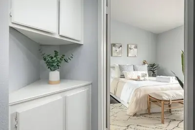 a white bedroom with a bed and a chair at GOODE HOMES Luxury Modern Home with Jacuzzi in Santa Clarita