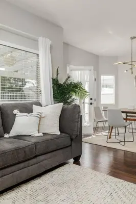 a living room with a couch and a dining room at GOODE HOMES Luxury Modern Home with Jacuzzi in Santa Clarita