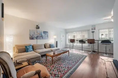 a living room with a couch and a table at Sawtelle Serenity- Modern Comfort in Los Angeles