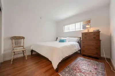 a bedroom with a bed and a chair and a dresser at Sawtelle Serenity- Modern Comfort in Los Angeles