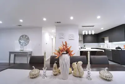 a living room with a table with a vase with pumpkins at Modern LA Home - King Bed, Outdoor Living, Firepit in Los Angeles