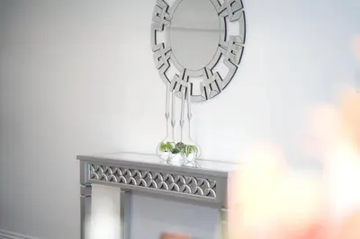 a mirror hanging on a wall above a table at Modern LA Home - King Bed, Outdoor Living, Firepit in Los Angeles
