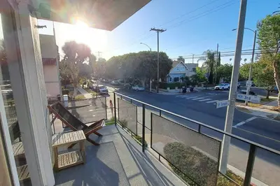 a balcony with a bench and a street at 2bdr Bluff Heights Condo walking distance to beach in Long Beach
