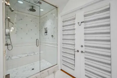 a shower with a glass door in a bathroom at The Getaway Oceanfront Villa in Malibu by Stay Awhile in Malibu