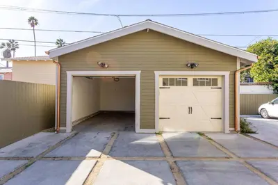 a garage with a garage door and a car at Getaway 4BR Home in the Heart of LA in Los Angeles