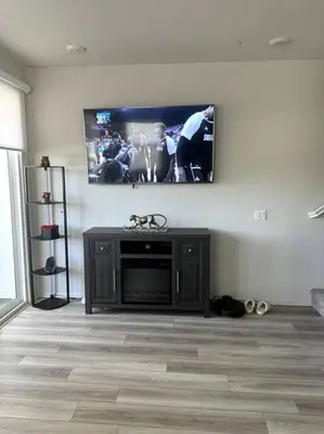 a living room with a flat screen tv on a wall at Cozy Home 20 Mins from DTLA in West Covina