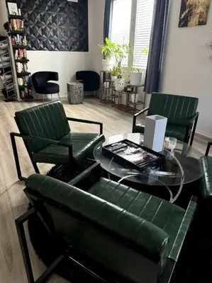 a living room with a glass table and green chairs at Cozy Home 20 Mins from DTLA in West Covina