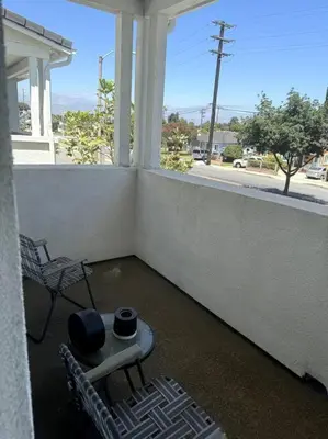 a porch with a table and chairs and a window at Cozy Home 20 Mins from DTLA in West Covina