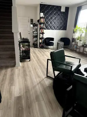 a living room with wooden floors and a staircase at Cozy Home 20 Mins from DTLA in West Covina