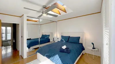 a bedroom with two beds and a ceiling fan at Coastal Retreat Steps from the Santa Monica Beach in Los Angeles