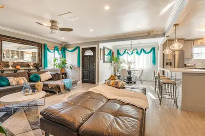 a living room with a couch and a table at 4 Mi to Beach Chic Los Angles Home with Patio! in Los Angeles