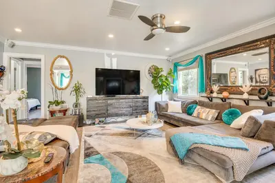 a living room with a couch and a tv at 4 Mi to Beach Chic Los Angles Home with Patio! in Los Angeles