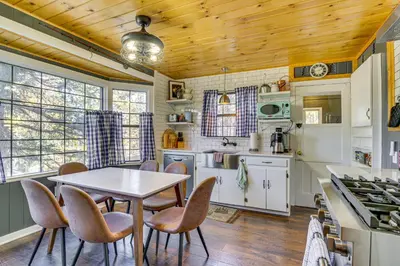 a kitchen with a table and chairs in a room at Hot Tub, Grill and Fire Pit Cabin in Big Bear Lake in Big Bear Lake