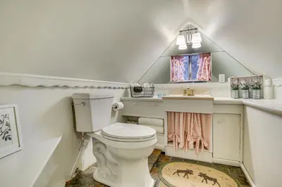 a bathroom with a white toilet and a sink at Hot Tub, Grill and Fire Pit Cabin in Big Bear Lake in Big Bear Lake