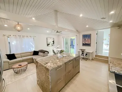 a kitchen and living room with a couch and a table at Pristine 1BD 1BA Bungalow With Hot Tub in Los Angeles