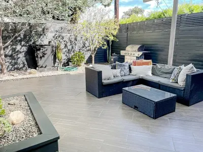 a patio with two couches and a fire place at Pristine 1BD 1BA Bungalow With Hot Tub in Los Angeles