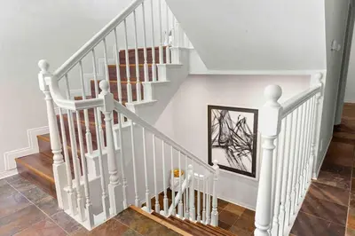 a staircase with white railings in a home at Stunning Mediterranean Mansion in Laurel Canyon in Los Angeles
