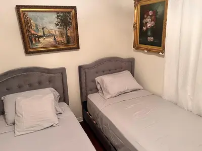 a bedroom with two beds and a painting on the wall at Stunning Mediterranean Mansion in Laurel Canyon in Los Angeles